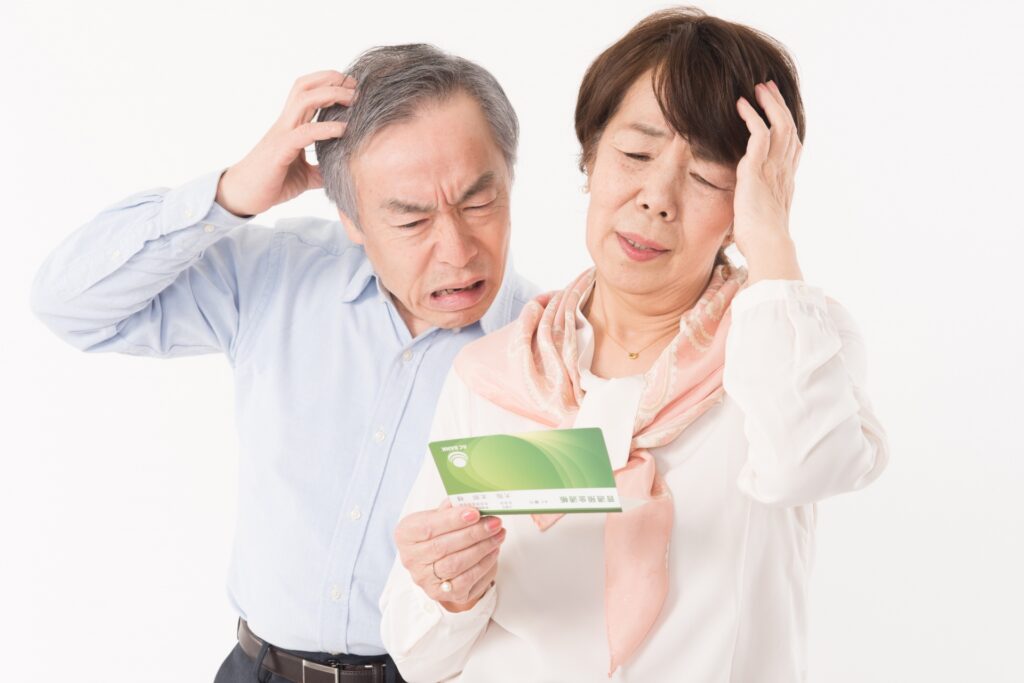 頭を抱える老夫婦